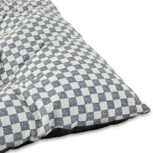 Black-and-white checkered tufted dog bed pillow fabric close-up
