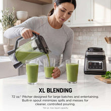 Blender pitcher pouring green smoothie into cups, with motor base and single-serve cup