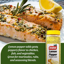 Herb-crusted salmon with lemon wedge and lemon pepper seasoning bottle