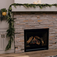 Green evergreen cedar garland across a fireplace mantel and surrounding trim