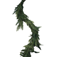 Green evergreen cedar garland with dense pine-like branches and layered tips