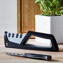 4-stage knife sharpener, black body with angled handle and blue-gray guide slots