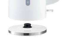 Base of white electric kettle with black heating plate center and metal ring
