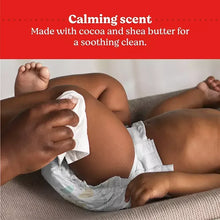 Baby being wiped with a white HUGGIES Nourish wipe