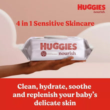 HUGGIES Nourish baby wipes container with white wipes held in a hand