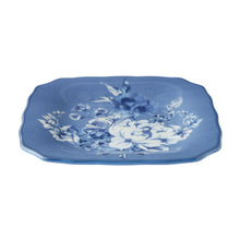 Blue stoneware appetizer plate with centered white bouquet and blue leaves