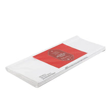 White wrapping tissue with red label on folded sheet package.