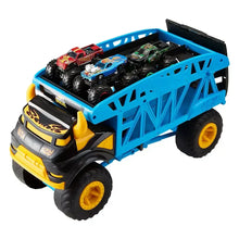 Blue toy monster truck with open bed holding four mini monster cars, yellow wheel rims