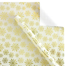 Floral wrapping paper with light yellow and green repeating snowflake-like motifs