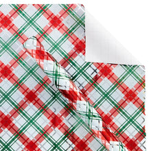 Plaid wrapping paper sheet with red and green grid and white accents