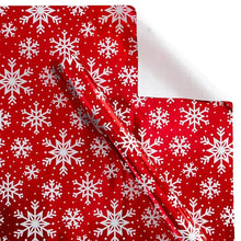 Wrapping paper sheet with red background and white snowflake pattern