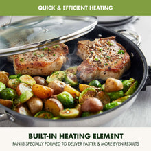 Electric skillet cooking with food inside and a tempered glass lid