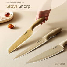 Stainless steel kitchen knives with cream blades and non-slip handles, laid out on counter.