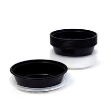 Stacked round food storage containers, dark bases with white rims and lids