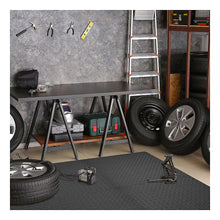 Interlocking dark gray foam floor tile mat with diamond plate texture in garage workspace