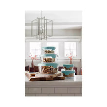 Glass food storage containers with teal lids in a kitchen display setting