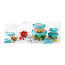 Glass food storage containers with teal lids holding food items, grouped together
