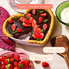 Heart-shaped stoneware baking dish with berry-topped baked dessert