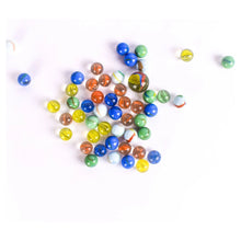 Scattered multicolor marbles, mostly blue and green with orange and yellow