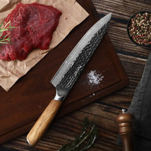 Damascus chef knife with olive-wood handle and hammered-pattern dark blade