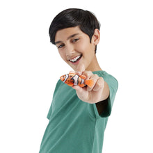 Orange robotic fish with patterned body on a child’s fingertip