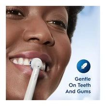 Electric toothbrush with white head in use, shown at the mouth