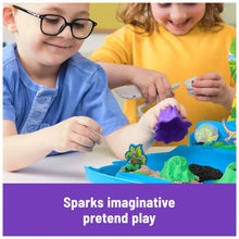 Kids playing with blue sand tray, dinosaur fossil molds, and green and purple sand