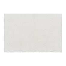 White plush micro polyester bath rug, rectangular with low pile surface.