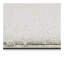 White plush bath rug close-up of low pile fibers.