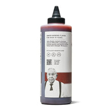 BBQ sauce bottle with black cap, back label with story text and barcode
