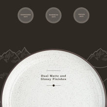 Speckled white ceramic dinner plate with dark rim and matte finish