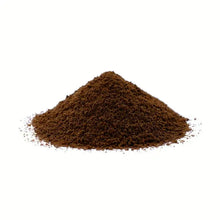 Ground coffee pile, dark brown powder