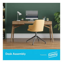 Desk assembly service by Handy with office desk, chair, and desk lamp setup