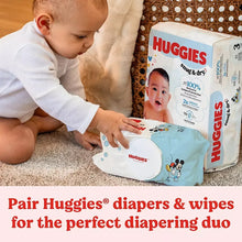 Baby using Huggies Simply Clean baby wipes on a couch