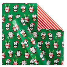 Reversible Christmas gift wrap with green penguin pattern and red-and-white stripes edge
