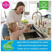Person washing dishes at sink with fragrance-free dish soap bottle and pink pump