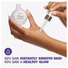 Two hands holding Olay Super Serum bottle and dispensing dropper serum