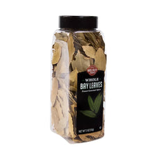 Whole bay leaves in a clear plastic jar, side view, black lid