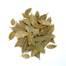 Pile of whole dried bay leaves with green-brown foliage