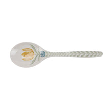 Serving spoon with flower at bowl and leaf pattern on the handle in light colors.