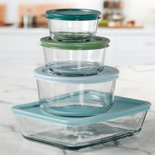 Stacked clear glass food storage container with teal lid and base