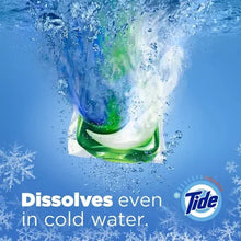 Tide PODS Spring Meadow detergent pod floating in water with dissolving foam