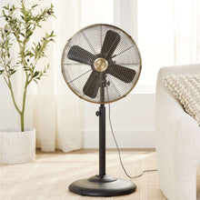 Black vintage metal stand fan on base with round wire grille and hub