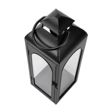 Black metal lantern candle holder with curved handle, arched top, and glass sides