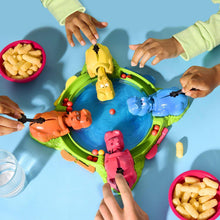 Hungry Hungry Hippos game board with toy hippos and marble pieces on table