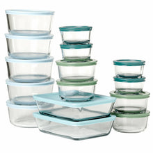 Stacked glass food storage containers with teal and green lids
