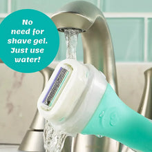 Water-rinsed women's razor with teal handle and silver blade cartridge at faucet.