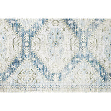 Close-up of cream geometric rug with blue distressed lattice and abstract motifs