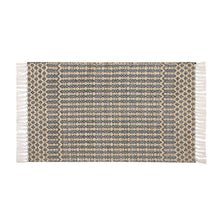 Woven accent rug with black, white, and beige geometric pattern and fringed border