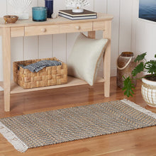 Rectangular accent rug with geometric weave in black, white, beige and white fringe